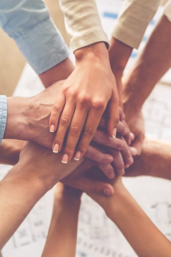 business-people-holding-hands-together_85574-13375